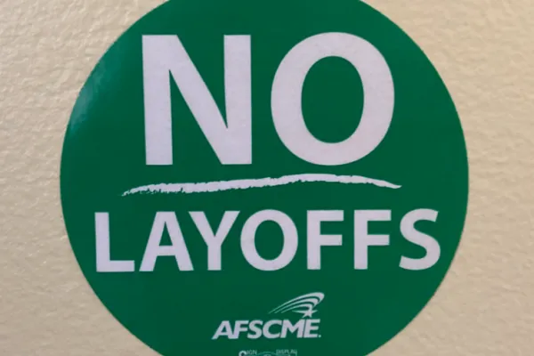 An AFSCME sticker saying "No Layoffs"