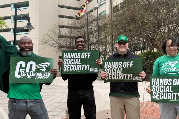 AFSCME members holding signs that say "Hands off Social Security"