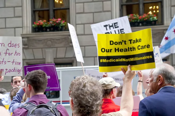 Sign reading "Don't Take Our Health Care'