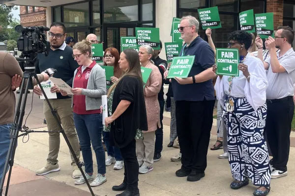 Members of Local 900 announce their strike authorization vote