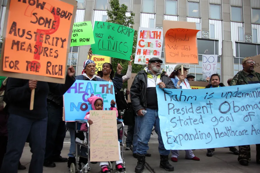 Concerned community members protest Rahm Emanuel's closure of city clinics in 2012.